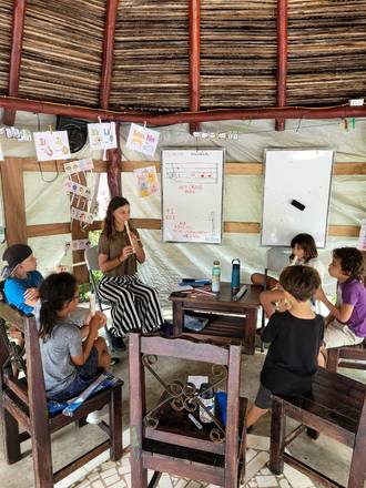 A recorder lesson under the thatch
