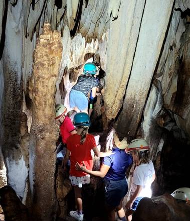 Exploring a cave in helmets