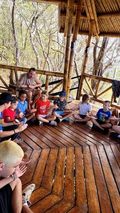 Sitting in a circle on the bamboo deck